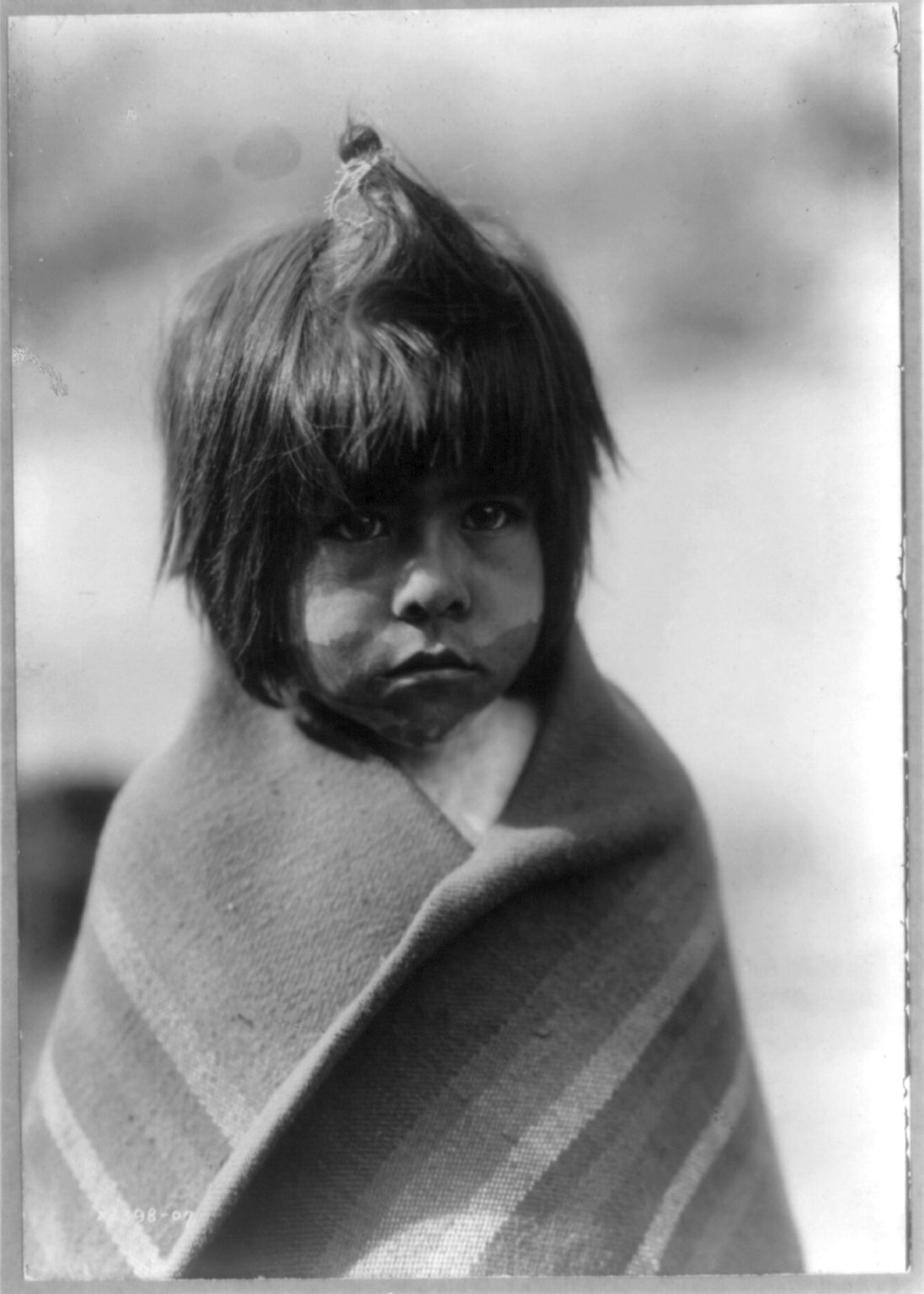 Portrait of a young Chemehuevi boy, photographed by Edward S. Curtis.