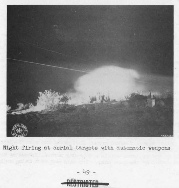 A night scene of tracer fire arcing into a dark sky above a burning desert ridge during an antiaircraft exercise.